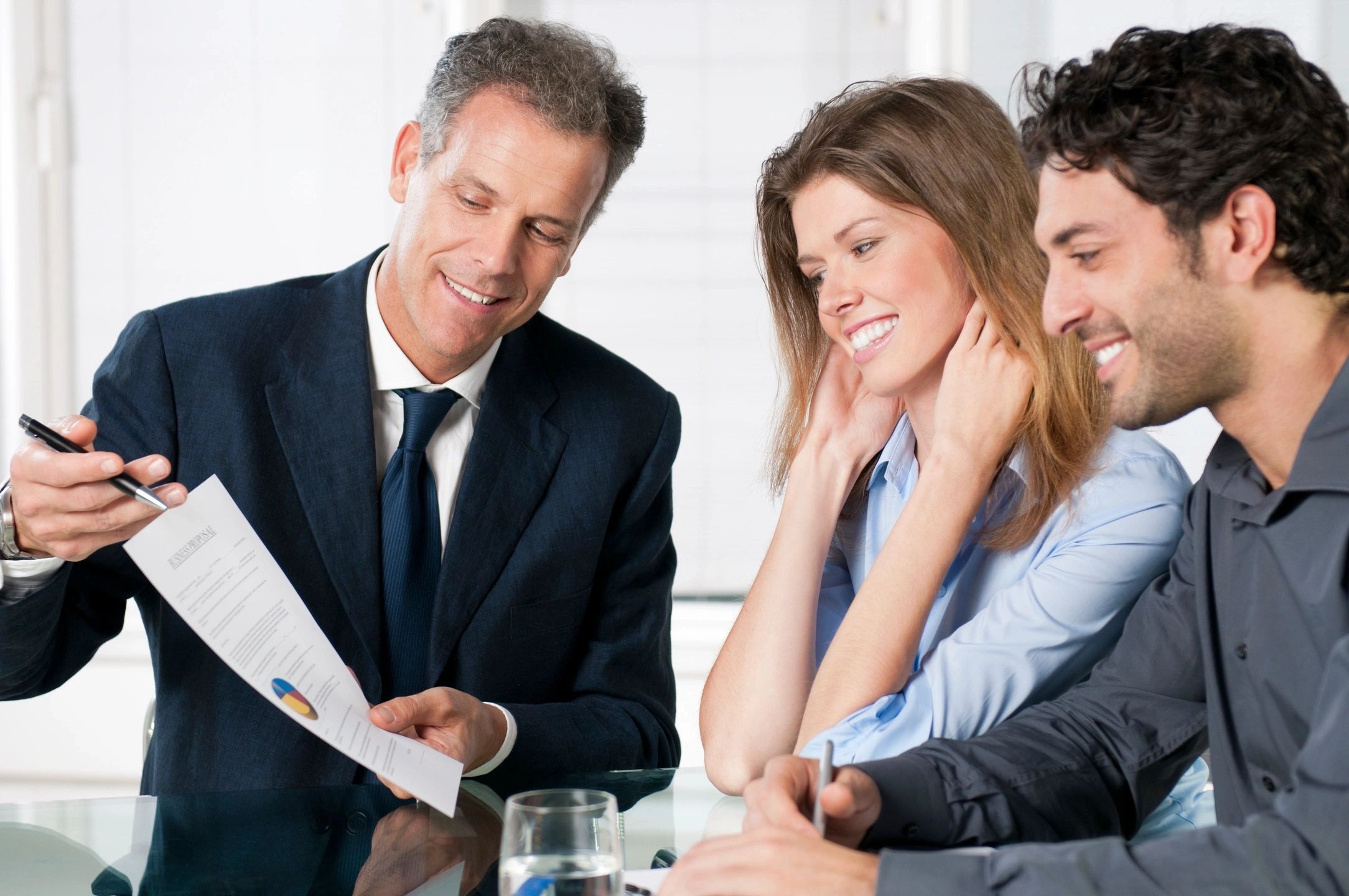 Business meeting with documents and smiling participants.